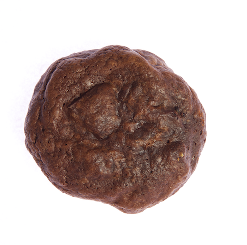 a round dark chocolate brownie cookie with chunks of dark chocolate 