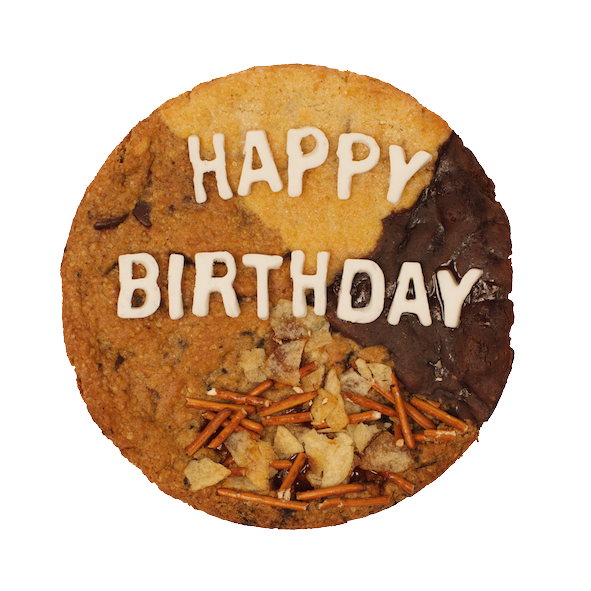 large cookie cake with multiple flavors that says Happy Birthday on top