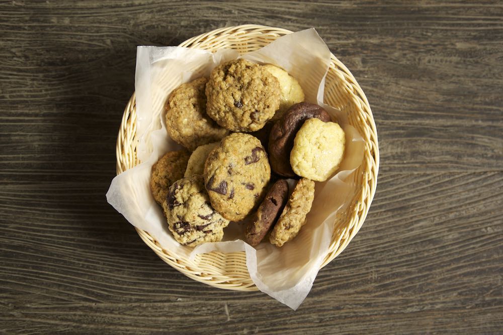 a basket of soft cookies on top of a wooden table